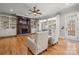 Bright and airy living room featuring hardwood floors, a fireplace, and built-in shelving at 4893 River Hills Dr, Denver, NC 28037