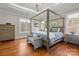 Spacious main bedroom featuring a four-poster bed, hardwood floors, and natural light at 4893 River Hills Dr, Denver, NC 28037