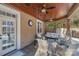 Cozy outdoor living space with comfortable seating and a wood ceiling with ceiling fans at 4893 River Hills Dr, Denver, NC 28037