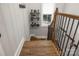 Wooden staircase with iron railings, leading to the upper level at 4893 River Hills Dr, Denver, NC 28037