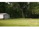 Large backyard with mature trees, a storage shed, and plenty of green space at 501 Catawba N Cir, Matthews, NC 28104