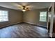 Spacious bedroom with two windows, new flooring and a ceiling fan at 501 Catawba N Cir, Matthews, NC 28104