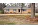 Charming brick ranch home with blue shutters and well-maintained landscaping at 501 Catawba N Cir, Matthews, NC 28104