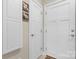 Hallway with multiple white doors and decorative artwork, providing access to different rooms at 505 2Nd Street Ne Pl # G-3, Conover, NC 28613