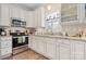 Bright kitchen with stainless steel appliances, sleek countertops, white cabinets, and hardwood floors at 505 2Nd Street Ne Pl # G-3, Conover, NC 28613