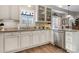 Modern kitchen featuring stainless steel appliances, granite countertops, white cabinetry, and hardwood floors at 505 2Nd Street Ne Pl # G-3, Conover, NC 28613