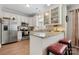 Well-lit kitchen with stainless steel appliances, granite counters, breakfast bar, and pristine white cabinets at 505 2Nd Street Ne Pl # G-3, Conover, NC 28613