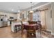 Eat-in kitchen featuring a stainless steel refrigerator and appliances, with a charming dining table nearby at 505 2Nd Street Ne Pl # G-3, Conover, NC 28613