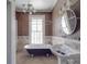 Bathroom featuring a clawfoot tub, stylish sink, and neutral tiling at 505 Camden Rd, Wadesboro, NC 28170