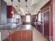 Spacious kitchen features dark wood cabinets, granite counters, and a central island with a unique design at 505 Camden Rd, Wadesboro, NC 28170