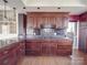 Kitchen boasts dark wood cabinetry, granite countertops and stainless steel appliances with modern fixtures at 505 Camden Rd, Wadesboro, NC 28170