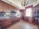 The kitchen features wooden cabinets, granite countertops, and dark backsplash, lit by a vintage chandelier at 505 Camden Rd, Wadesboro, NC 28170