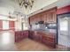 Updated kitchen with hardwood floors, granite counters, and a central island featuring dark wood cabinetry at 505 Camden Rd, Wadesboro, NC 28170