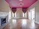 Cozy living room featuring a fireplace, hardwood floors, and natural light streaming in from the windows at 505 Camden Rd, Wadesboro, NC 28170