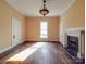 Living room features a fireplace, hardwood floors, and natural light at 505 Camden Rd, Wadesboro, NC 28170