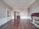 Living room featuring a built-in display case, fireplace, and hardwood floors at 505 Camden Rd, Wadesboro, NC 28170