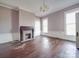 Large living room with hardwood floors, fireplace, and abundant natural light at 505 Camden Rd, Wadesboro, NC 28170