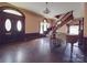 Inviting living room with hardwood floors, grand staircase, and classic architectural features at 505 Camden Rd, Wadesboro, NC 28170