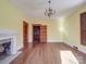 Spacious living room with hardwood floors, fireplace, and ornate light fixture at 505 Camden Rd, Wadesboro, NC 28170