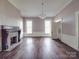 Bright living room with fireplace, hardwood floors, and vintage chandelier at 505 Camden Rd, Wadesboro, NC 28170