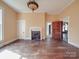 Bright living room with hardwood floors, fireplace, and doorway to another room at 505 Camden Rd, Wadesboro, NC 28170