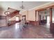 Inviting living room showcasing a staircase, wood trim, a piano, and classic design elements at 505 Camden Rd, Wadesboro, NC 28170