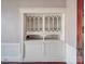 Living room featuring a built-in display case, hardwood floors, and detailed trim at 505 Camden Rd, Wadesboro, NC 28170