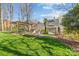 Picturesque backyard with lush lawn, pergola, fire pit and mature trees, creating a serene outdoor space at 5618 Camilla Dr, Charlotte, NC 28226