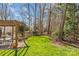 Lush backyard featuring a wooden pergola with a dining set, fire pit, and ample green space at 5618 Camilla Dr, Charlotte, NC 28226