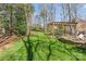 Expansive backyard featuring lush lawn, pergola, and fire pit area, perfect for relaxation and entertainment at 5618 Camilla Dr, Charlotte, NC 28226