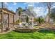 Stunning backyard with a stone fire pit and a covered patio, perfect for outdoor gatherings and relaxation at 5618 Camilla Dr, Charlotte, NC 28226