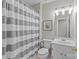 Clean bathroom with striped shower curtain, toilet, sink, and vanity at 5618 Camilla Dr, Charlotte, NC 28226