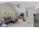 Cozy bonus room features a large leather couch, tv, and natural light at 5618 Camilla Dr, Charlotte, NC 28226