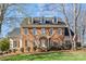 Charming two-story brick home with dormer windows and a well-manicured front lawn at 5618 Camilla Dr, Charlotte, NC 28226