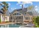 Luxury backyard with screened-in porch, pool, spa and well-manicured landscaping for entertainment at 5618 Camilla Dr, Charlotte, NC 28226
