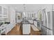 Bright kitchen with white cabinets, stainless steel appliances, and an island cooktop at 5618 Camilla Dr, Charlotte, NC 28226