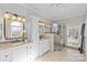 Main bathroom featuring double vanities, a glass shower, and decorative mirror at 5618 Camilla Dr, Charlotte, NC 28226