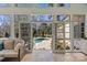 Sunroom opens to stunning backyard with large in-ground pool and lounge area at 5618 Camilla Dr, Charlotte, NC 28226