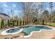 Backyard oasis with in-ground pool, spa, and manicured landscaping at 5618 Camilla Dr, Charlotte, NC 28226