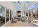 Bright sunroom featuring a fireplace, tile flooring and comfortable seating at 5618 Camilla Dr, Charlotte, NC 28226
