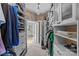 Organized walk-in closet with custom shelving and a view into the bathroom at 5618 Camilla Dr, Charlotte, NC 28226