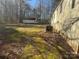 View of the backyard with two small sheds and an air conditioning unit by the mobile home at 5909 Crawford Rd, Gastonia, NC 28052