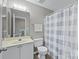 Cozy bathroom featuring a shower-tub combo, toilet, vanity with sink, and a mirror at 6057 Creft Cir, Indian Trail, NC 28079