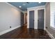 Spacious room with hardwood floors, two doors and neutral wall color at 6108 Phyliss Ln, Mint Hill, NC 28227