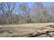 Expansive backyard offers a serene setting, with a lush ground cover and abundant trees at 648 E Ketchie St, China Grove, NC 28023