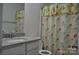 Bathroom features a granite countertop, floral shower curtain, and well-maintained fixtures at 648 E Ketchie St, China Grove, NC 28023