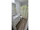 Bathroom featuring a granite-look vanity, a stylish shower curtain, and wood-look flooring at 648 E Ketchie St, China Grove, NC 28023