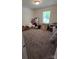 Carpeted bedroom featuring a sunny window, neutral walls, and ample space at 648 E Ketchie St, China Grove, NC 28023