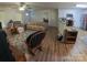 Spacious living room with hardwood flooring, ceiling fan, and an easy flow to the kitchen and dining area at 648 E Ketchie St, China Grove, NC 28023
