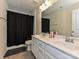 Well-lit bathroom featuring double sinks, a shower with a curtain, and tile flooring at 7015 Walnut Branch Ln, Charlotte, NC 28277